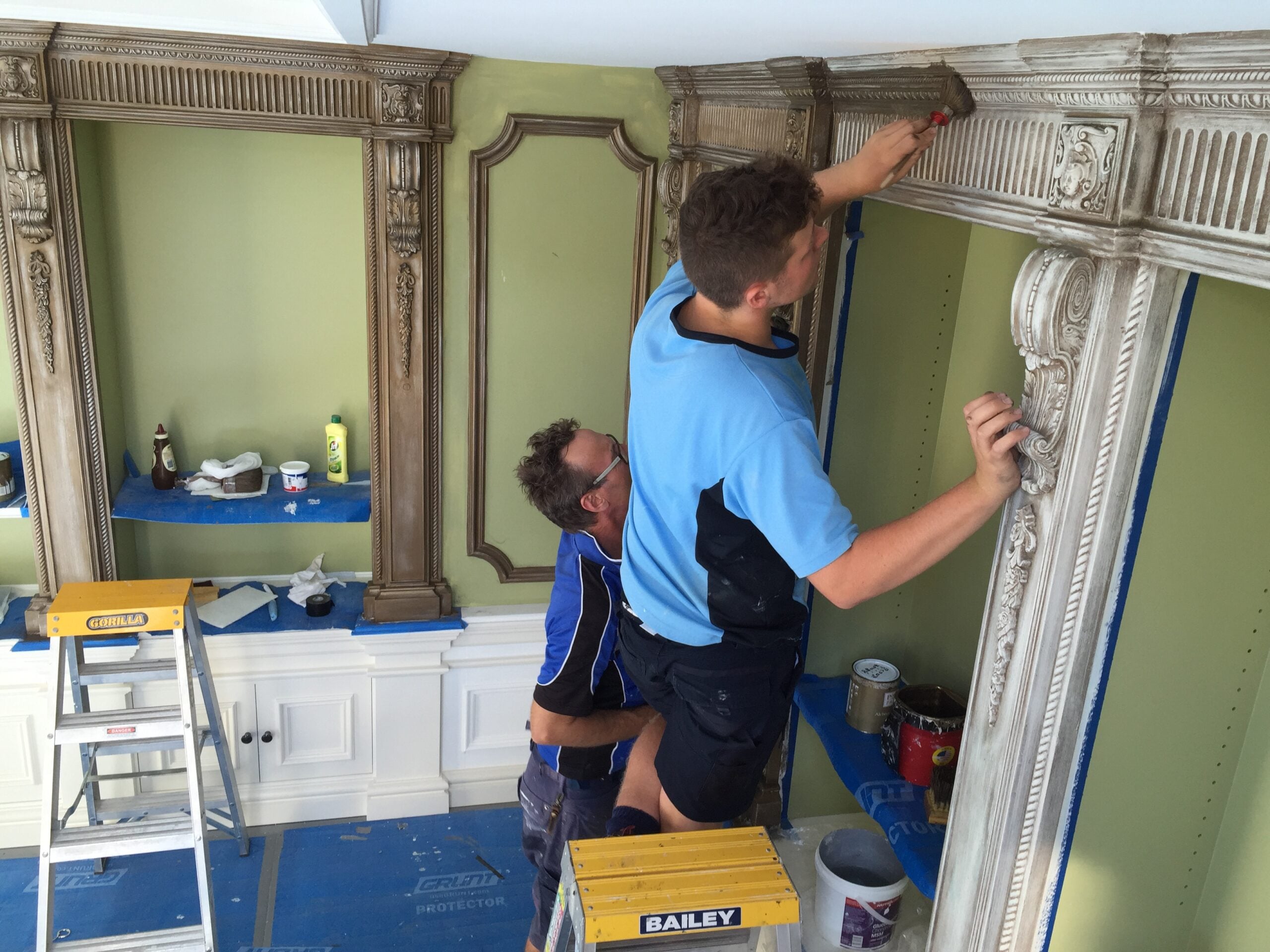 Passing on Traditional Craftsmanship Amos and Oliver Groth applying decorative finishes to bespoke joinery as part of the Groth & Sons family tradition of craftsmanship.