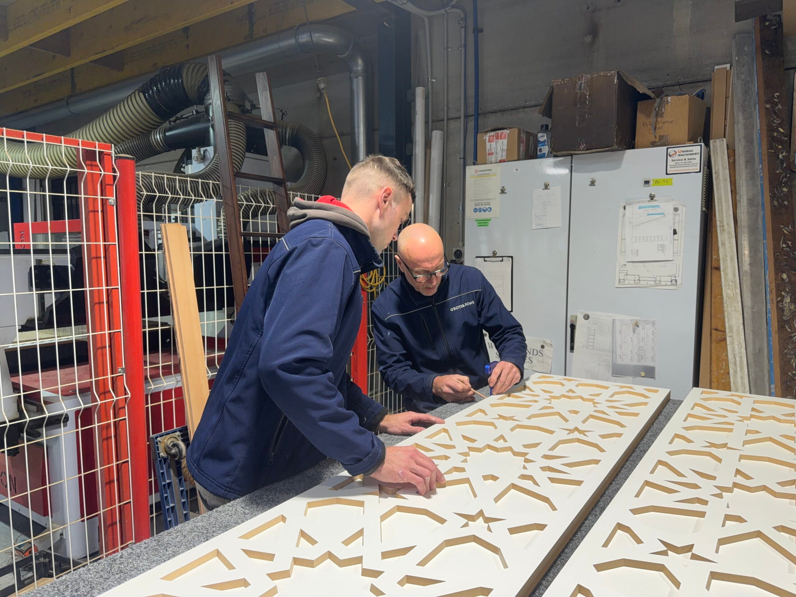 Amos and Oscar – Craftsmanship in the Workshop Amos and Oscar Groth reviewing custom CNC-cut joinery panels together in the Groth & Sons workshop.