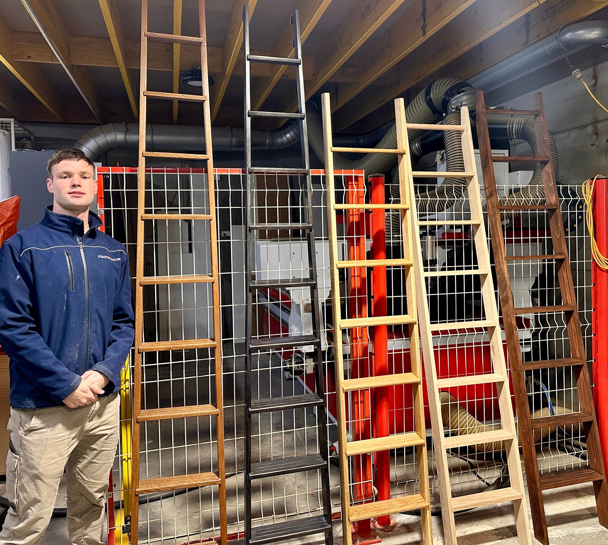 Oscar Groth with Bespoke Library Ladders Oscar Groth with a collection of handcrafted bespoke timber library ladders in the Groth & Sons workshop.
